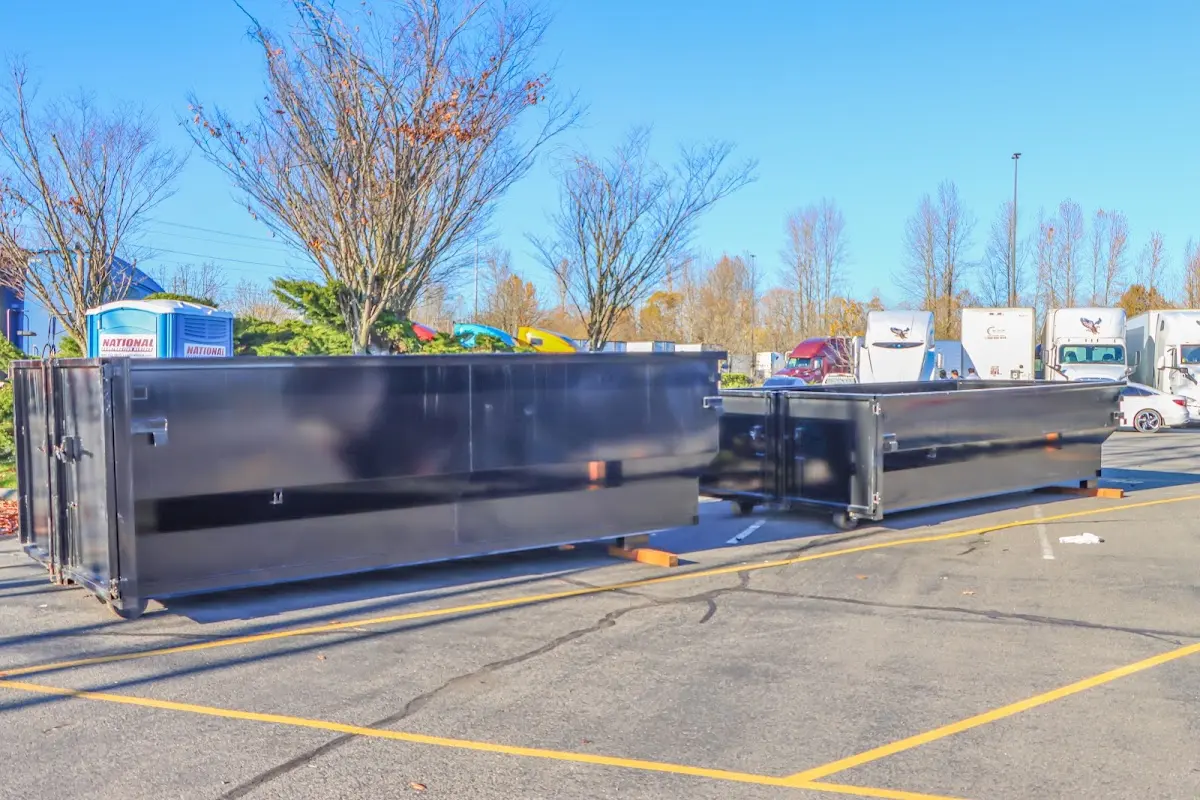 Professional dumpster rental service with roll-off container on residential driveway in Toppenish